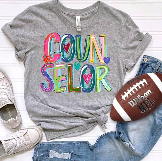 Counselor on grey tee or crew school spirit